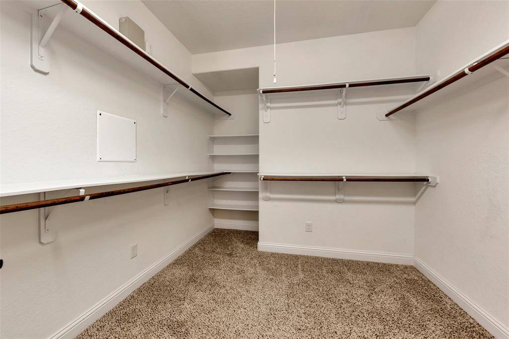 There is ample space to hang your dresses and coats in the oversized walk-in primary closet. Built-ins provide additional space for your bags and shoes.