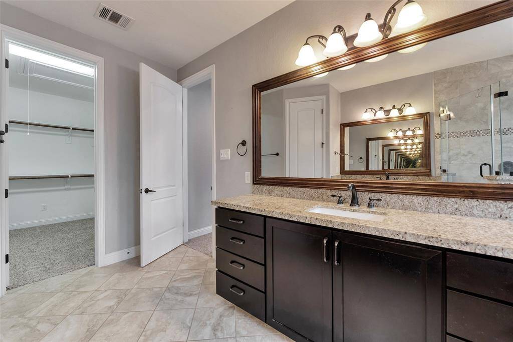 A view of the walk-in closet from the primary bath.