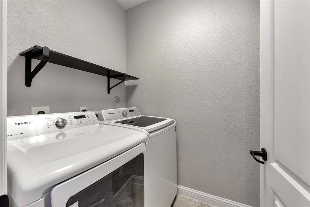 The utility room includes washer, dryer, and a rack for cleaning supplies.