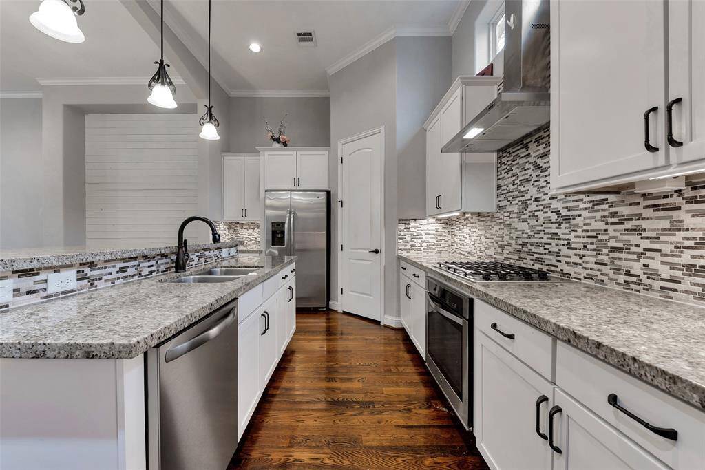The oversized kitchen features granite countertops, stainless steel appliances, a pantry, and plenty of cabinets for all your cooking and entertaining needs.
