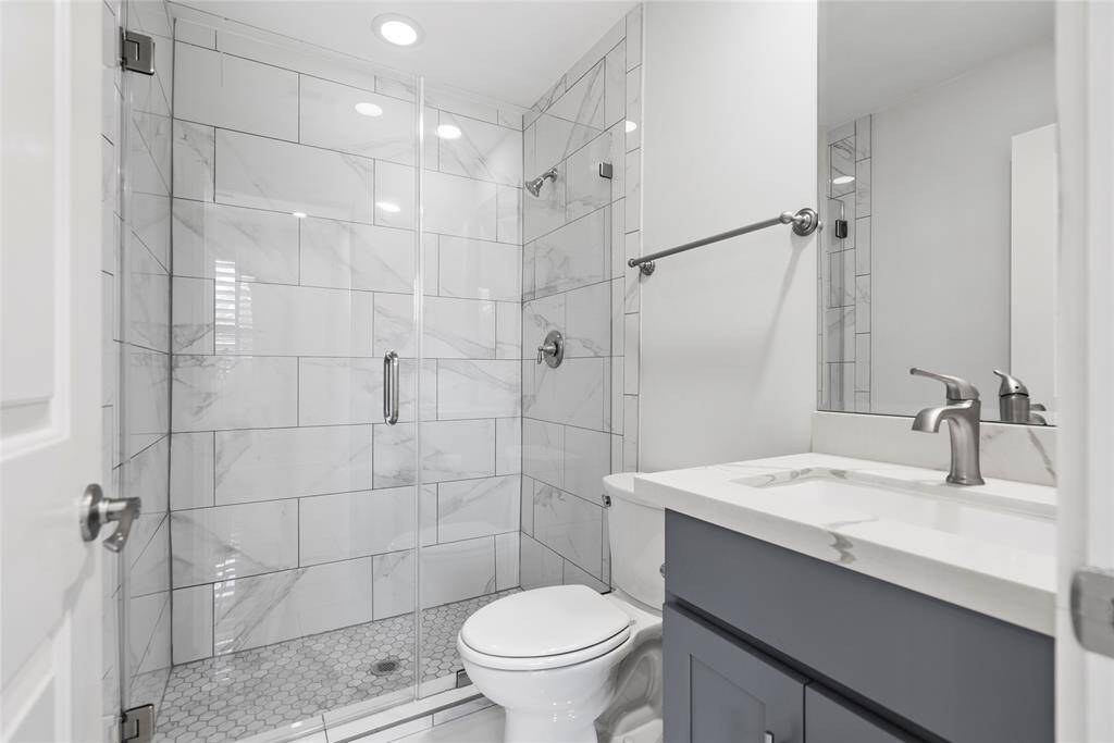 Downstairs Ensuite Bath with frameless shower door. Stylish and modern.