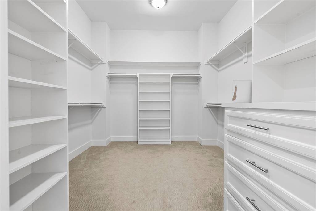 Huge walk in Primary Closet with tons of built ins suited for anyone with a huge wardrobe