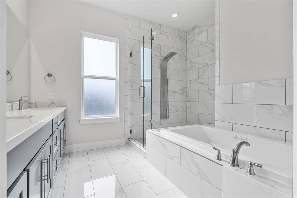 Beautiful Primary Bath with multi jetted shower complete the primary bedroom