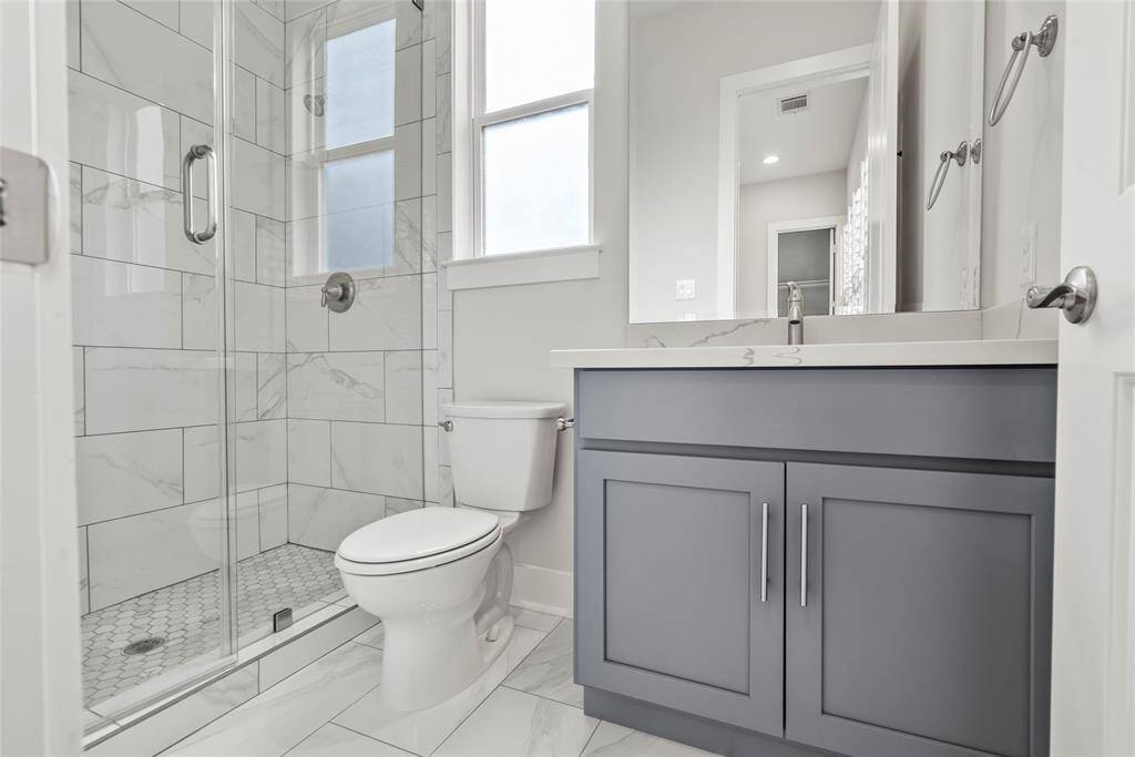 Ensuite bath for the 3rd floor secondary bedroom which also has a frameless shower door