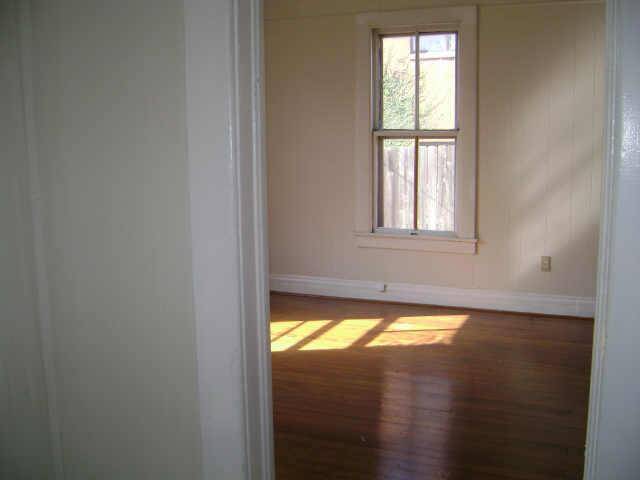 file picture when home was vacant to show hardwood floors and natural light