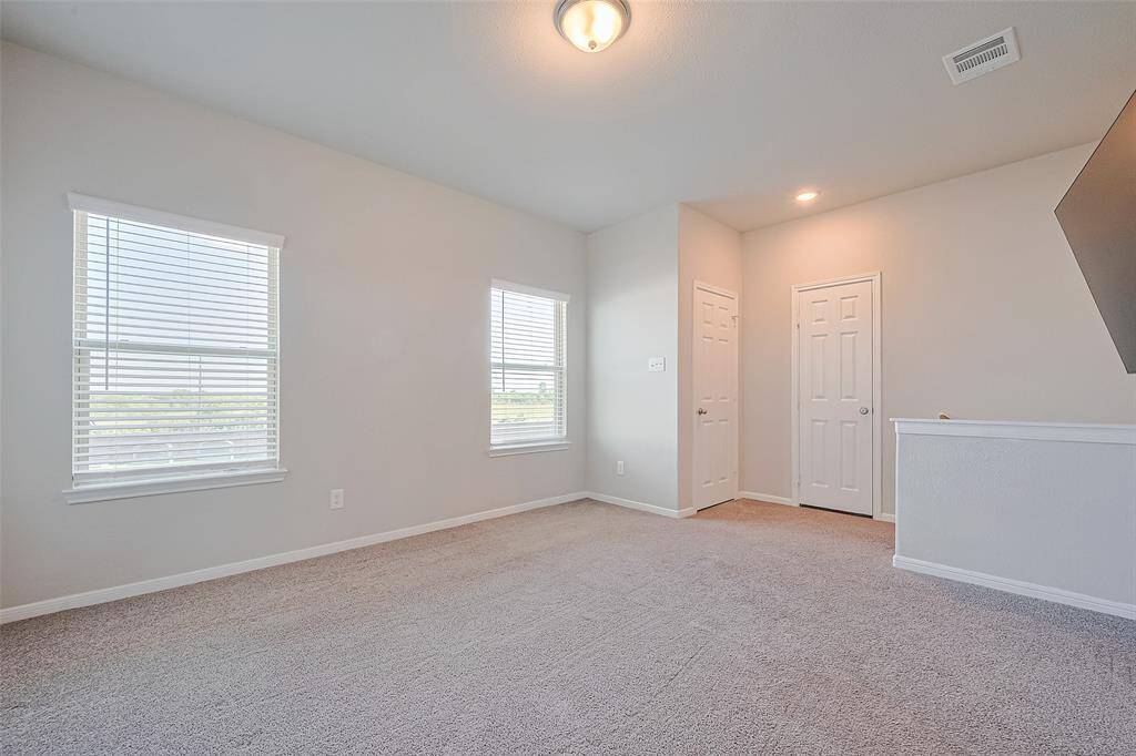Generously sized and bathed in light from oversized windows, this versatile upstairs game room invites creativity—whether for play, relaxation, or entertainment.