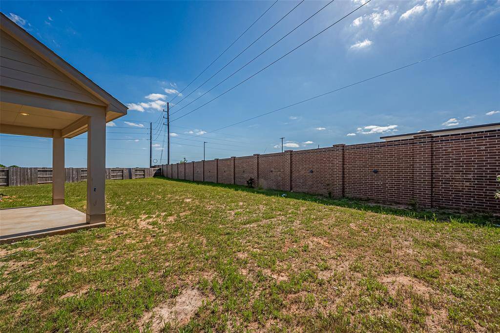 Step out onto the covered patio and enjoy year-round outdoor living. Whether for morning coffee or weekend grilling, this spacious area extends the living space with ease.