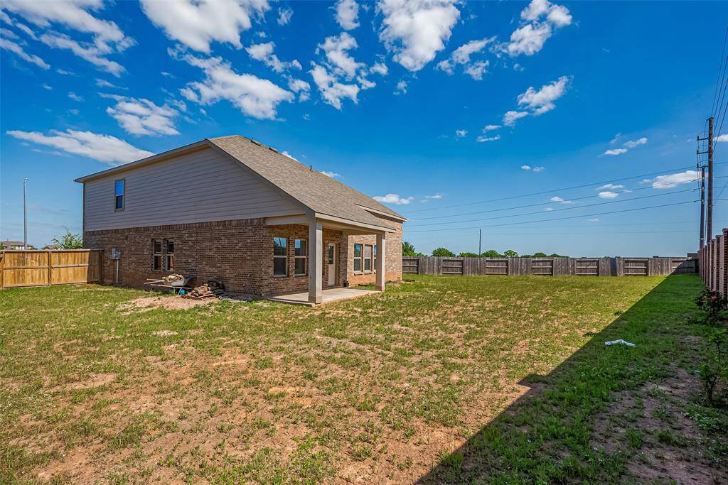 A blank canvas ready for imagination, the vast fenced backyard offers both privacy and potential—perfect for gardening, play, or even future enhancements.