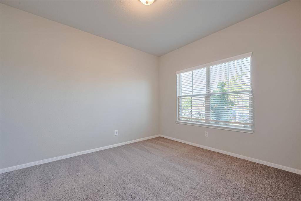 A quiet retreat for productivity, this carpeted office features a generous window and double doors. Soft natural light filters in, making it ideal for focused work or creative pursuits.