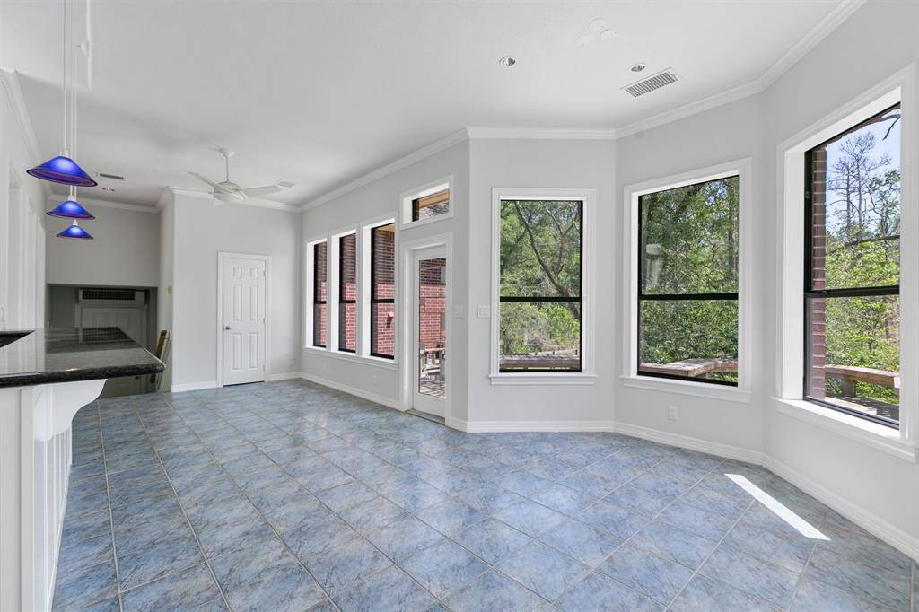This bright, open space breakfast room features a bay window with scenic views of the backyard and deck.