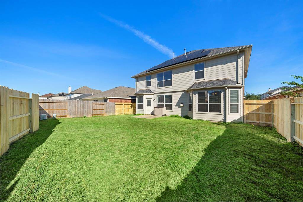 The private fenced yard offers ample space for outdoor activities in a serene setting. Ideal for relaxation or entertaining, the expansive green space creates a welcoming outdoor retreat, enhanced by the home's quiet cul-de-sac location and proximity to a scenic water view.