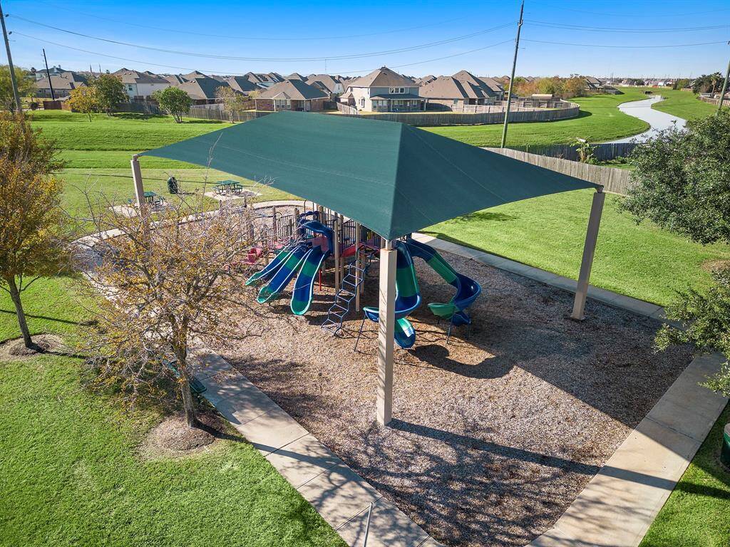 Discover the vibrant community space in Rodeo Palms, featuring a well-equipped playground nestled amidst expansive green surroundings. This area offers a delightful setting for outdoor enjoyment, complete with shaded seating and scenic views of the tranquil neighborhood canal. Ideal for leisurely afternoons and neighborly gatherings.