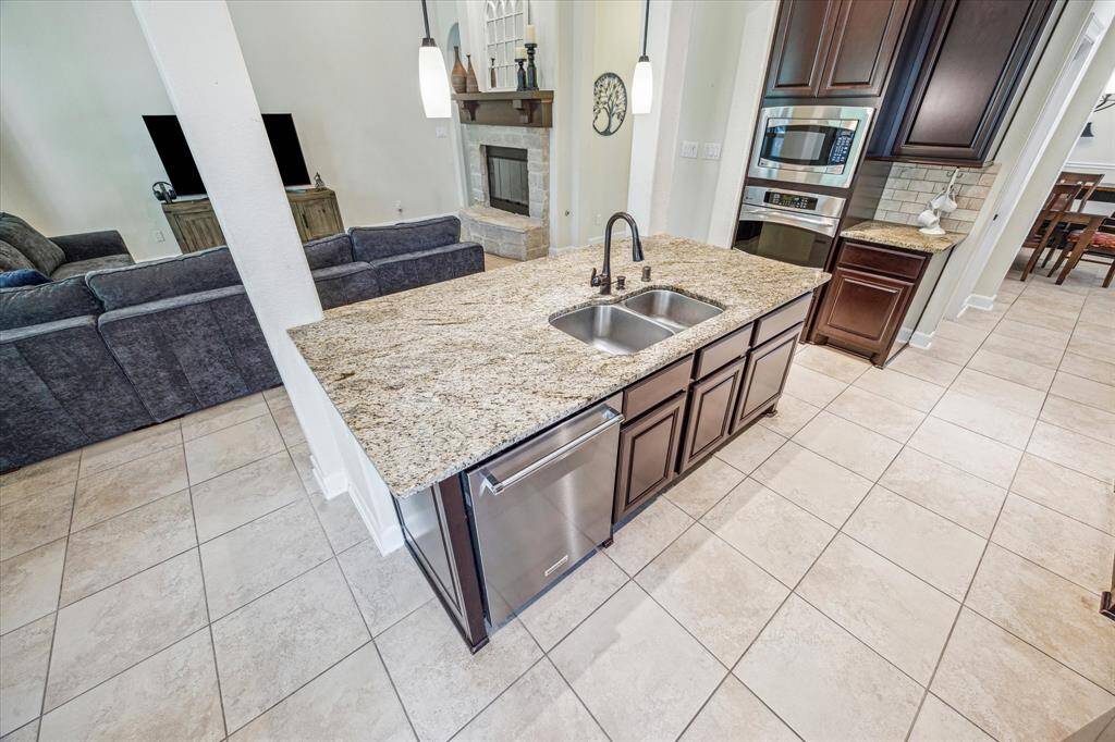 Large Granite Island with Sink and Dishwasher and Lots of Storage * Pendant Lighting * Bar Seating on the Other Side of the Island.