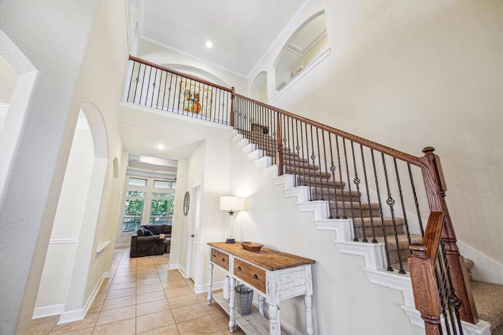 Two Story Entry * Stairs with Iron Balusters * Light and Bright * Art Niche on the Left.