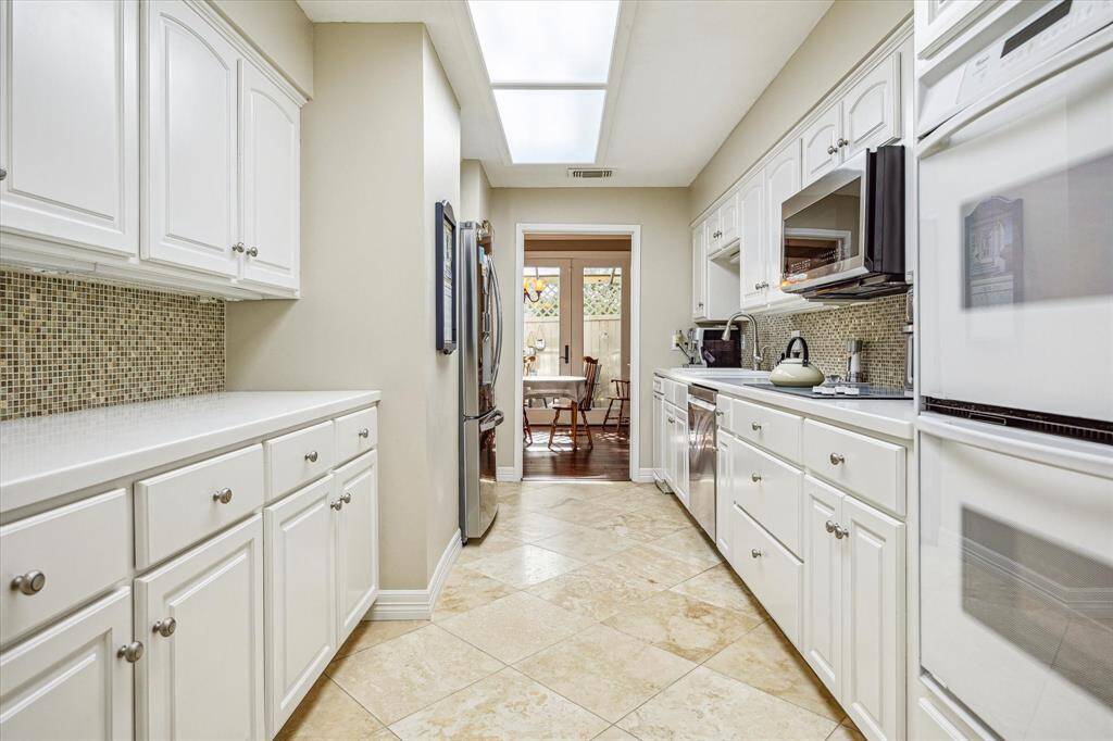 With plenty of counter space and storage, double ovens, and more, this kitchen can meet your every need. Access to the garage makes it easy to bring groceries in, and access to the dining room makes your daily life a breeze.