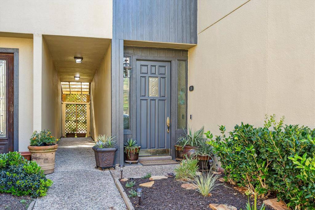 A landscaped front yard and gorgeous black door greet you as you walk up to the home.