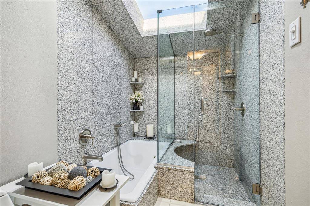 As you continue through the bathroom, you are met with a spa-like scene. Featuring a sky light, separate shower, and soaking tub.