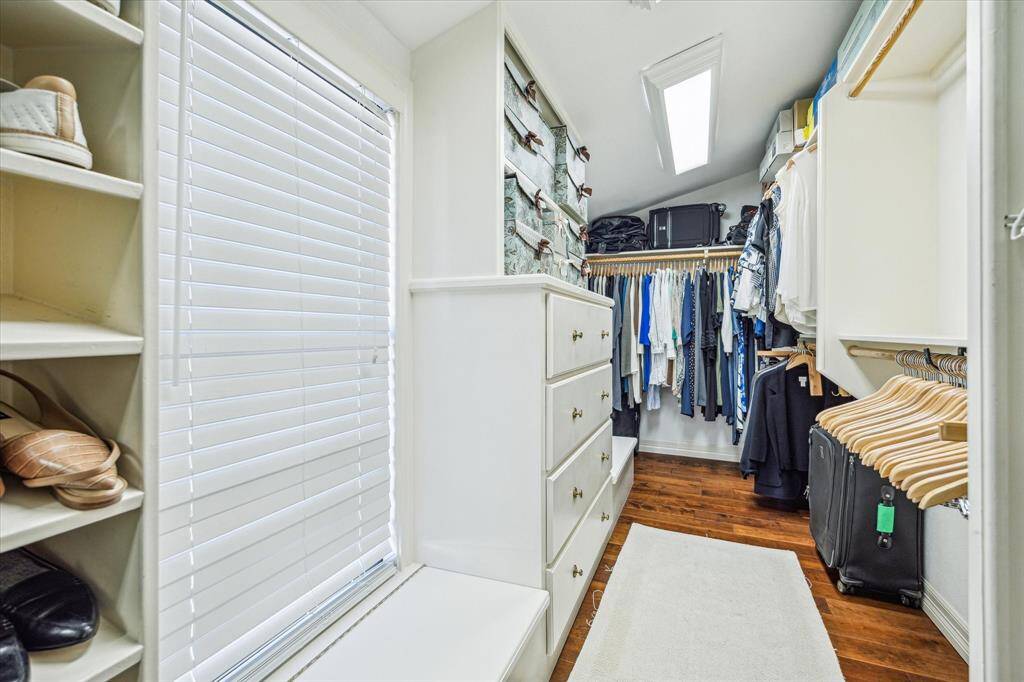 The walk-in closet features built-ins and plenty of storage space.
