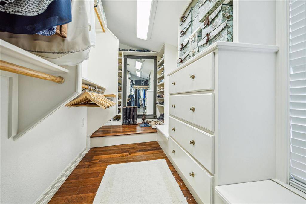 A step up in the primary adds a boutique element to your closet. See all the shoe storage!