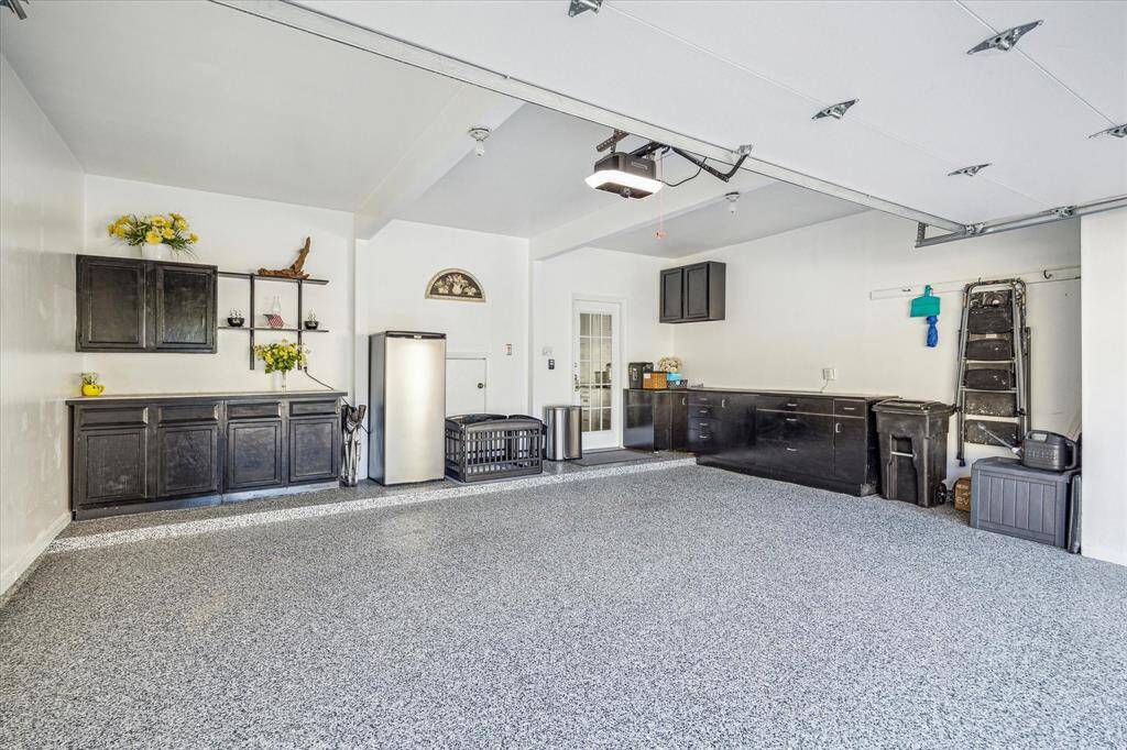 The oversized 2-car garage has so much storage! Plenty of room for racks or a separate outdoor workspace. *The garage door and garage door opener were replaced in 2024. *per seller