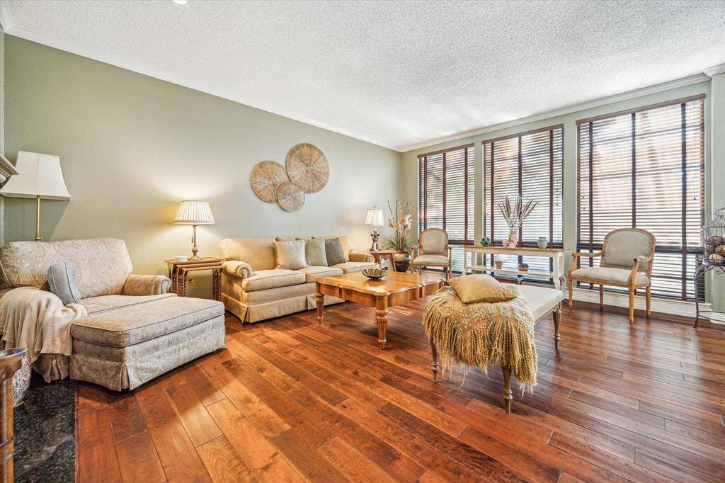 Off the dining room is a spacious living room with a fireplace. A wall of windows brings in tons of natural light.
