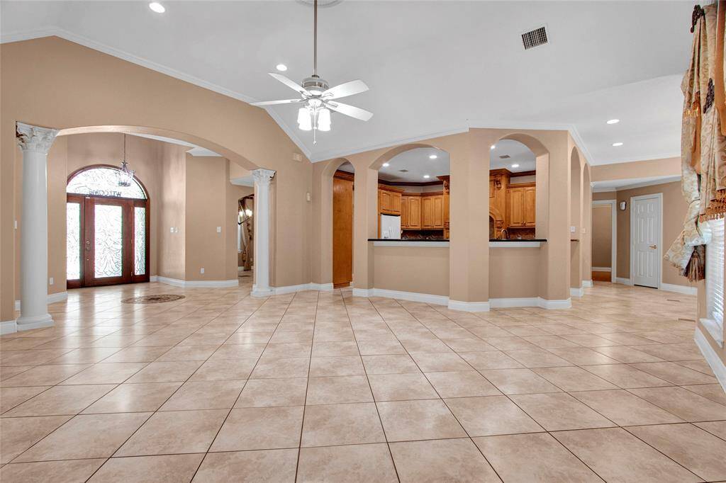 Living room view to main entrance and kitchen