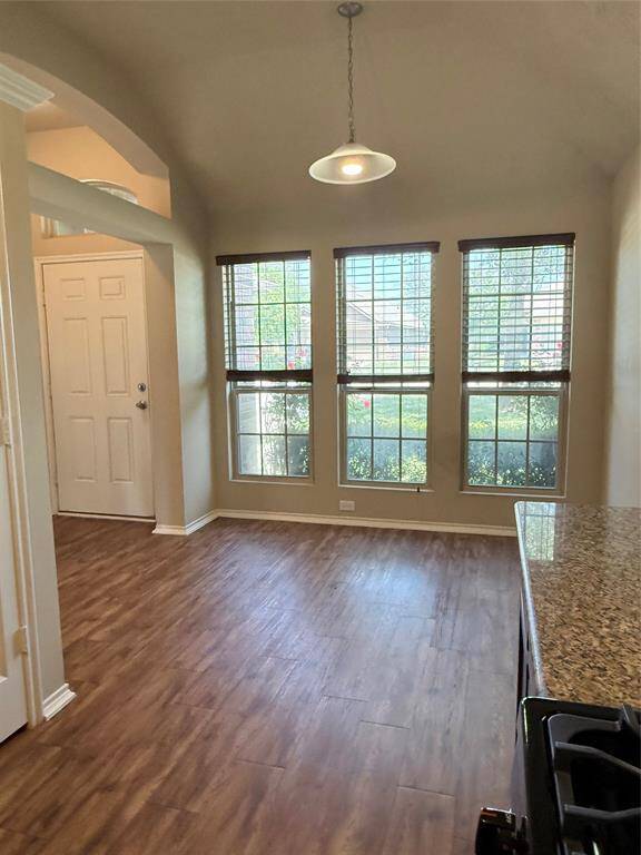 Dining room open to kitchen; entryway with archway