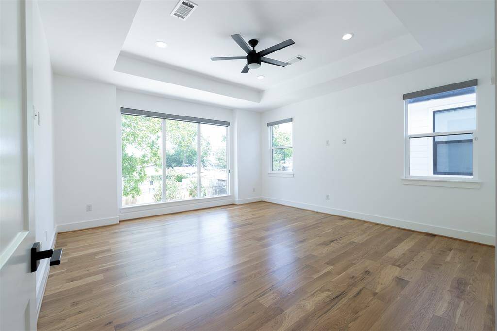 Large primary suite with coffered ceiling has plenty of room for a sitting area!