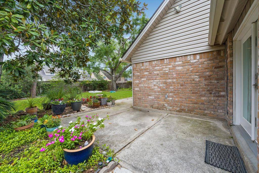 Step into your beautiful backyard, with patio, mature trees, and a large green space.