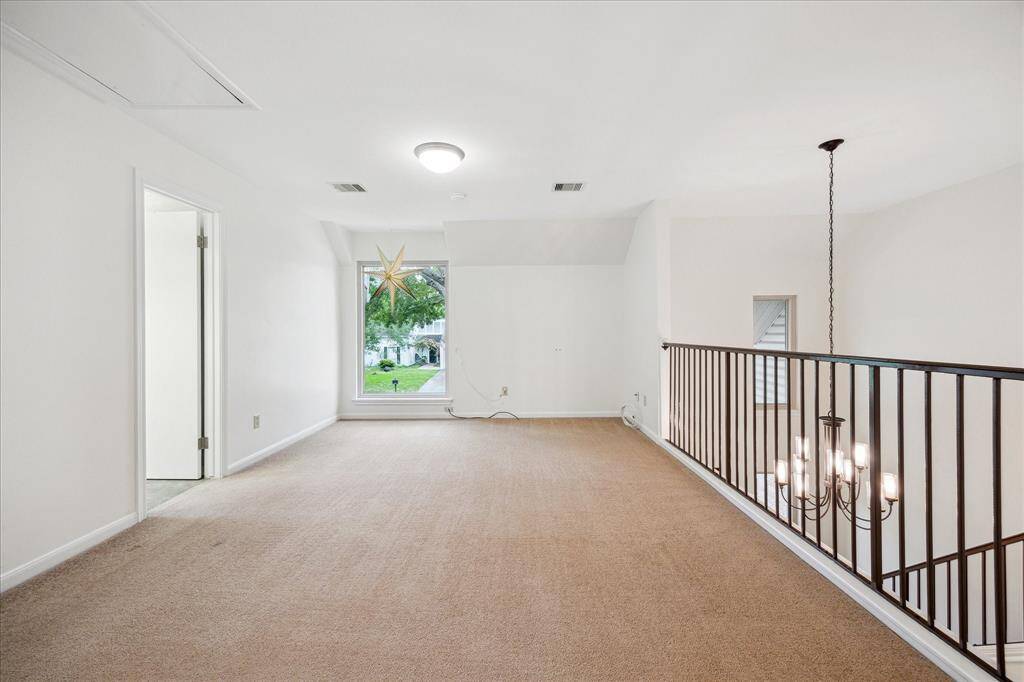 The second floor game room is open to the living room below.