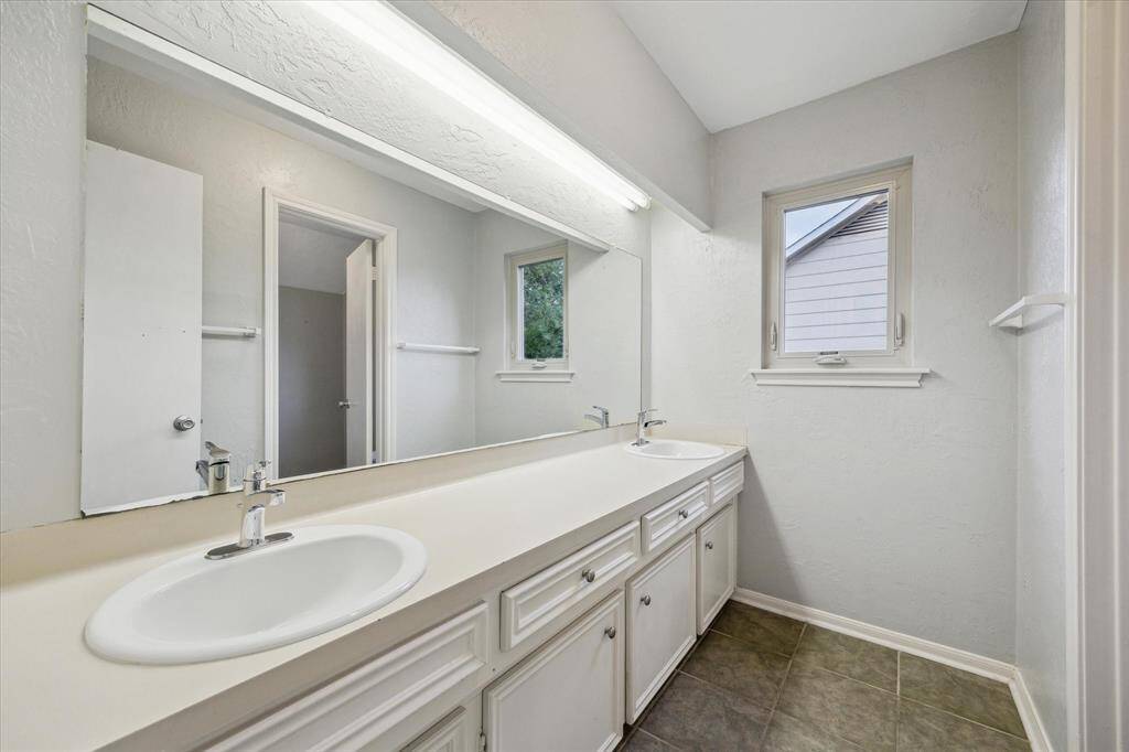 The second floor bathroom provides double sinks.