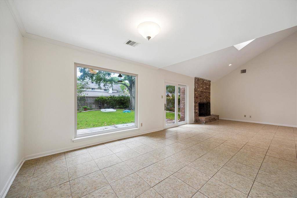 The formal dining room is open to the living room and offers an expansive picture window to the backyard oasis.