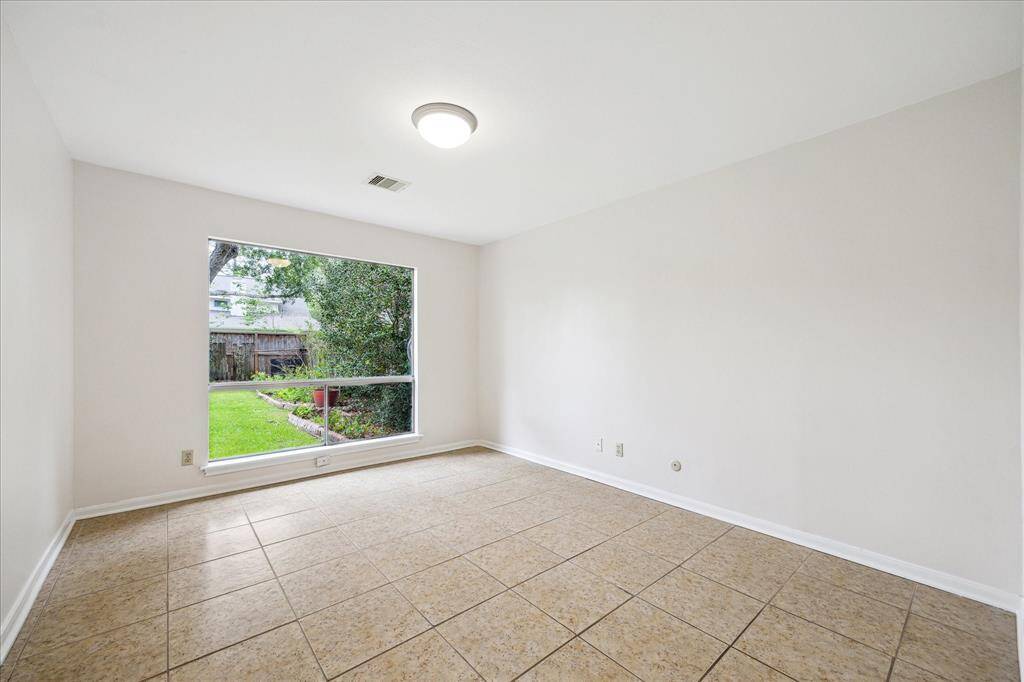 A dedicated office located off of the living room also boasts a large picture window with backyard views.