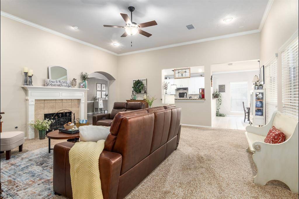 A look coming from the primary bedroom. Gas log fireplace, high ceilings and a great open view into the breakfast/kitchen spaces. This home has great flow!