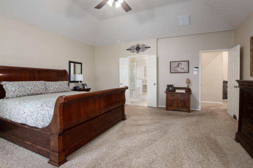 Here's the primary bedroom! This room is very spacious at approx. 19' x 17'. The door entrance to the left leads you to the primary bathroom and the door to the right takes you back to the family room.
