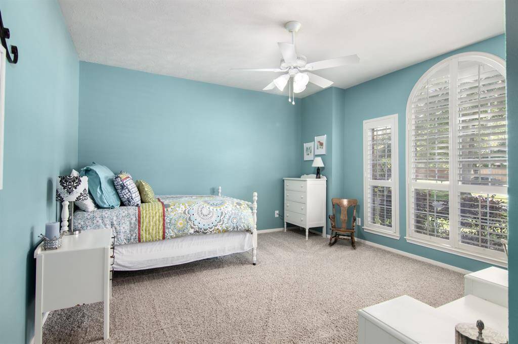 Bedroom 4 is ANOTHER spacious bedroom. More pretty arched windows allowing great light into this room. These windows have plantation shutters too as this room looks out to the front. Did I say ALL bedrooms have large, walk-in closets?