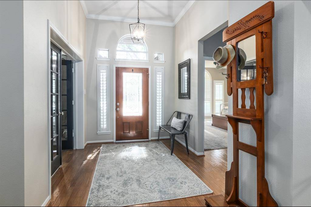 Welcome in! A view of the entry looking toward the front door. Gorgeous natural light! The door on the left leads you into the office/study and the right opening leads to 1 of the 4 bedrooms & 1 of 3 full bathrooms.