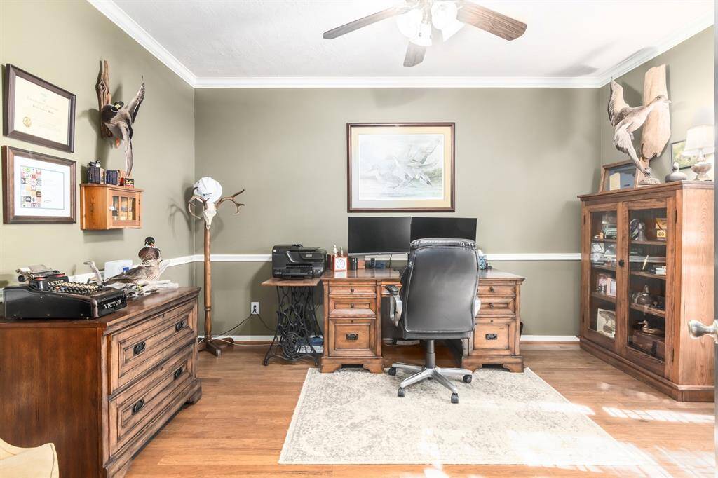 Off the entry and through the french doors is the spacious office with pretty wood floors. It overlooks the front yard too!