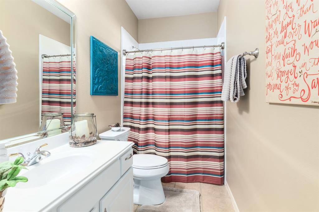 The first of 3 full baths sits right outside the front bedroom. A space perfect for guests!