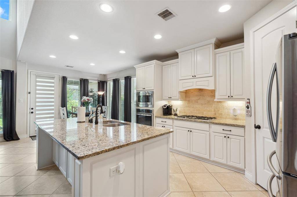 Beautiful cabinetry in this home with extra seating at the island!