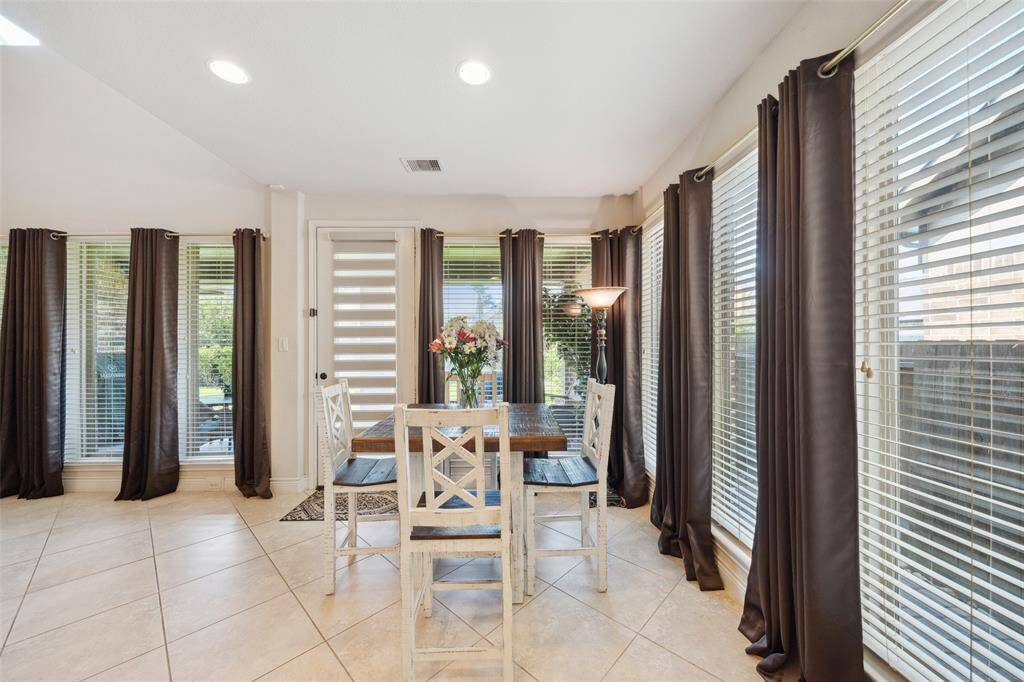 Light filled breakfast area with large windows overlooking the side and back yards.