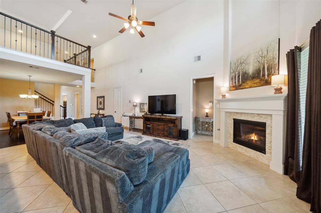Looking from the breakfast area to the living space with game room/loft above.