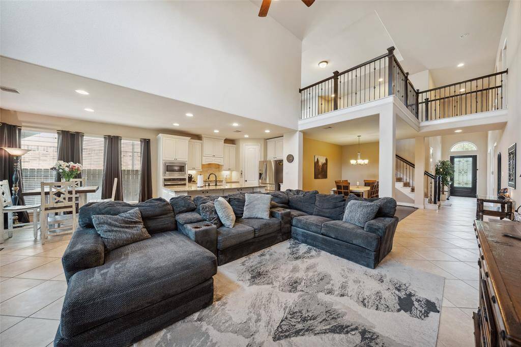Beautiful living space with loft area above and catwalk to guest bedrooms offers visual interest.