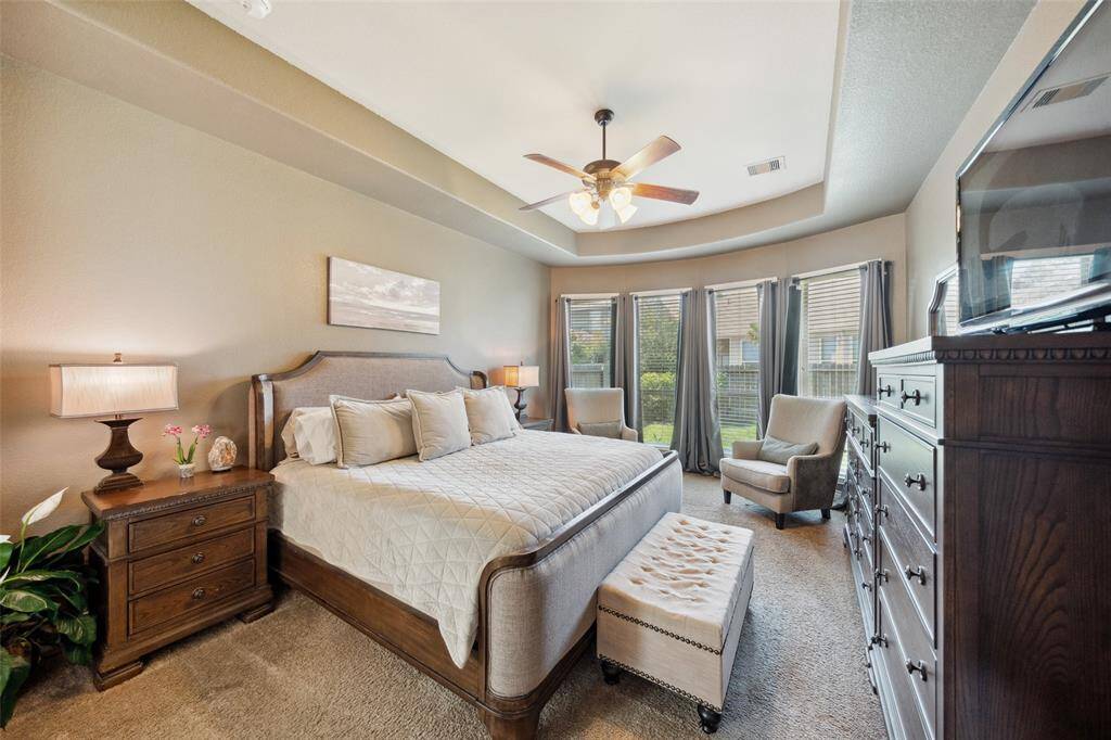Large primary bedroom with bay window overlooking the back yard.