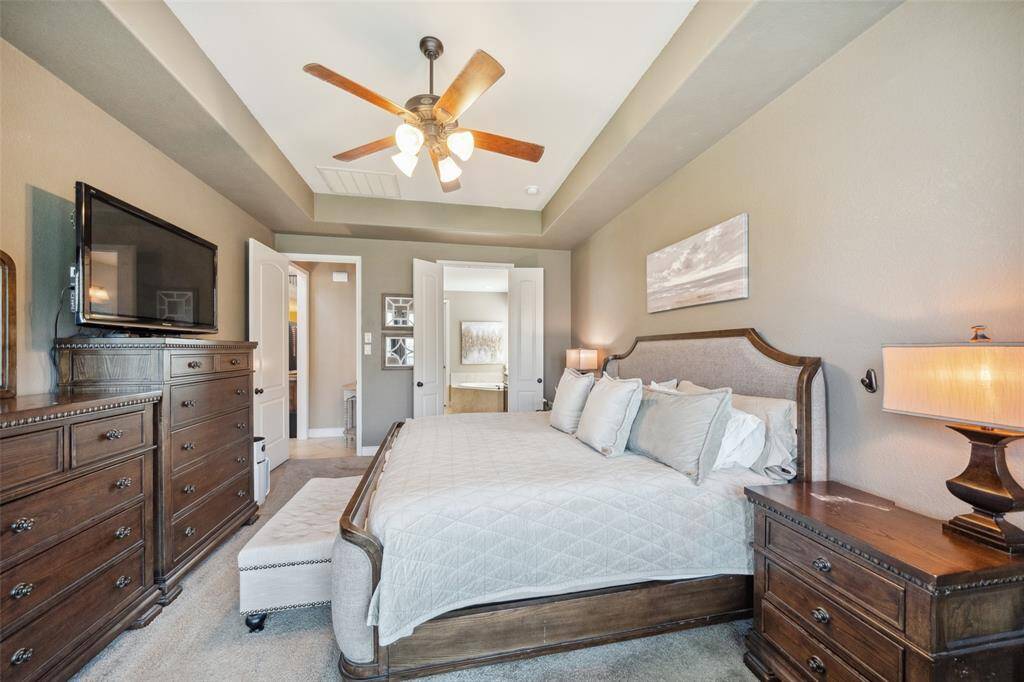 Primary bedroom features a tray ceiling for added height and en-suite bath.