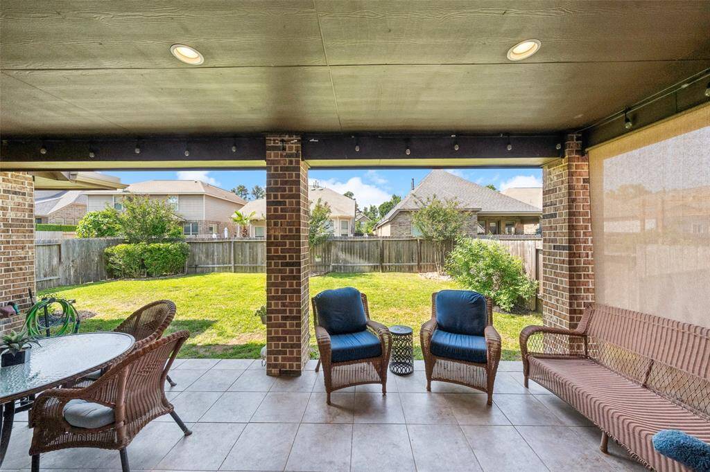 Large back porch is big enough for a couple of seating areas.