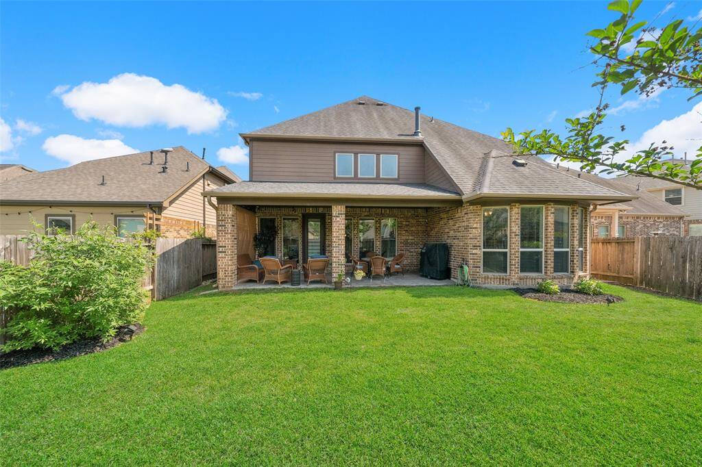 Large back yard grassy area ready for pets or outdoor games, or add your own pool, if desired.