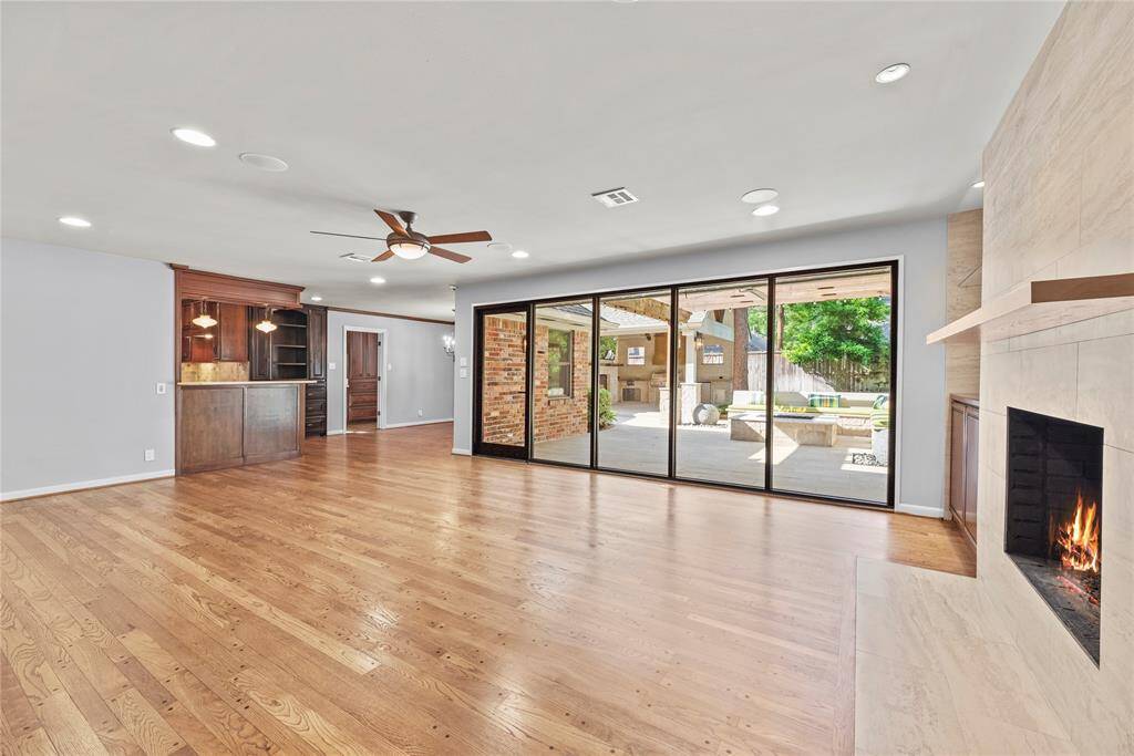 A full view of the bright and inviting living room, anchored by a contemporary fireplace and clean architectural lines.
