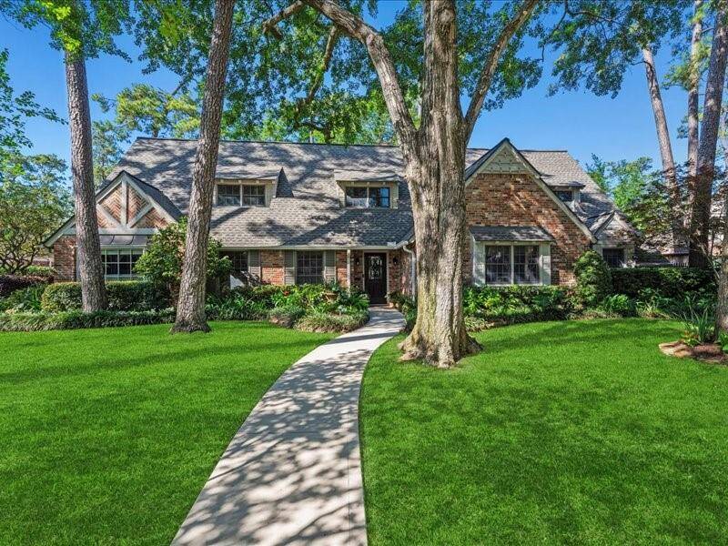 Welcome to 12214 Cobblestone Dr! This charming brick exterior and mature trees frame this classic two-story home, set back on a spacious manicured lawn with a curved walkway leading to the Mahogany front door.