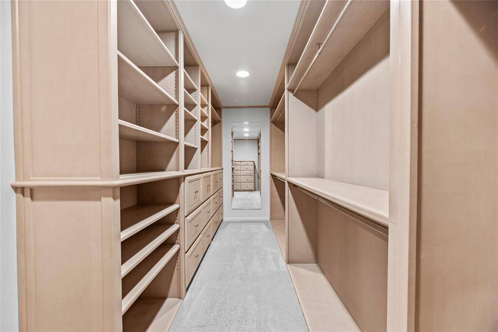 A dream customized closet with built-in shelving, ample drawer space, and hanging storage—designed to keep everything organized and within reach.